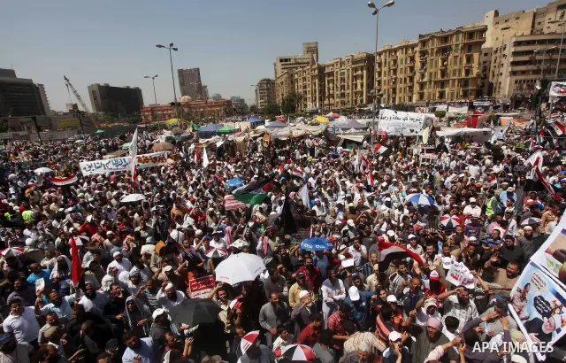 People attend Friday prayers in Tahrir Square in Cairo April 27, 2012. Tens of thousands of Egyptians demanded on Friday that their military rulers stick to a pledge to hand over power by mid-year after a row over who ca...
