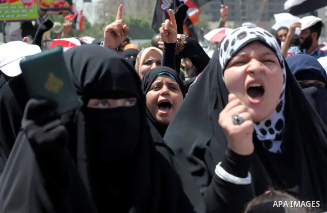 People attend Friday prayers in Tahrir Square in Cairo April 27, 2012. Tens of thousands of Egyptians demanded on Friday that their military rulers stick to a pledge to hand over power by mid-year after a row over who ca...