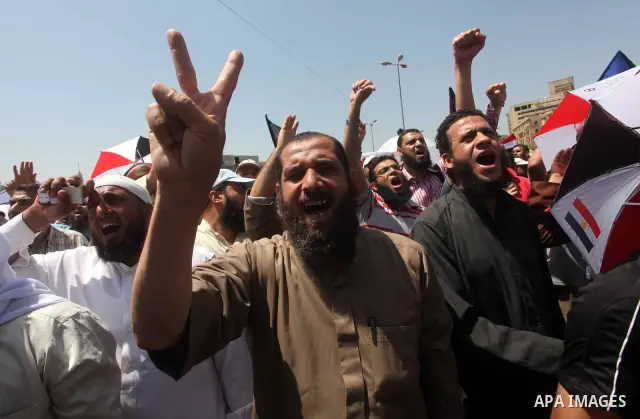 People attend Friday prayers in Tahrir Square in Cairo April 27, 2012. Tens of thousands of Egyptians demanded on Friday that their military rulers stick to a pledge to hand over power by mid-year after a row over who ca...