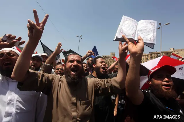 People attend Friday prayers in Tahrir Square in Cairo April 27, 2012. Tens of thousands of Egyptians demanded on Friday that their military rulers stick to a pledge to hand over power by mid-year after a row over who ca...