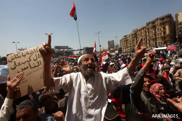 People attend Friday prayers in Tahrir Square in Cairo April 27, 2012. Tens of thousands of Egyptians demanded on Friday that their military rulers stick to a pledge to hand over power by mid-year after a row over who ca...