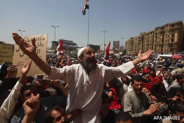 People attend Friday prayers in Tahrir Square in Cairo April 27, 2012. Tens of thousands of Egyptians demanded on Friday that their military rulers stick to a pledge to hand over power by mid-year after a row over who ca...