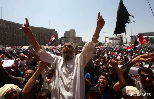 People attend Friday prayers in Tahrir Square in Cairo April 27, 2012. Tens of thousands of Egyptians demanded on Friday that their military rulers stick to a pledge to hand over power by mid-year after a row over who ca...