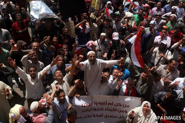 People attend Friday prayers in Tahrir Square in Cairo April 27, 2012. Tens of thousands of Egyptians demanded on Friday that their military rulers stick to a pledge to hand over power by mid-year after a row over who ca...