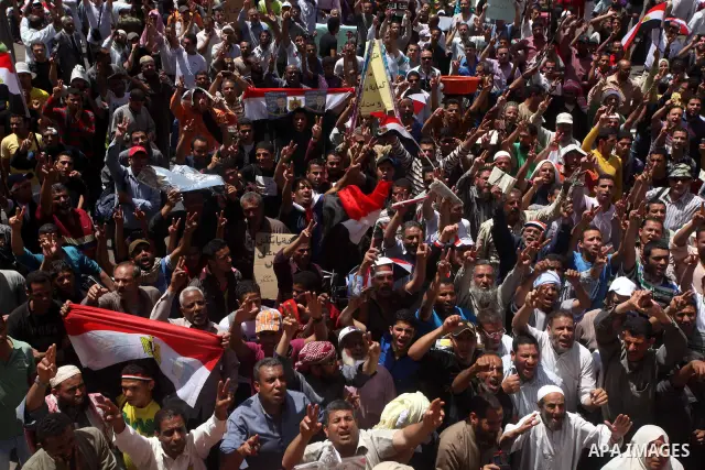 People attend Friday prayers in Tahrir Square in Cairo April 27, 2012. Tens of thousands of Egyptians demanded on Friday that their military rulers stick to a pledge to hand over power by mid-year after a row over who ca...