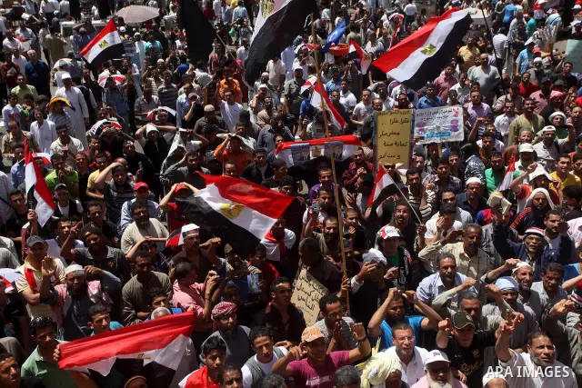 People attend Friday prayers in Tahrir Square in Cairo April 27, 2012. Tens of thousands of Egyptians demanded on Friday that their military rulers stick to a pledge to hand over power by mid-year after a row over who ca...