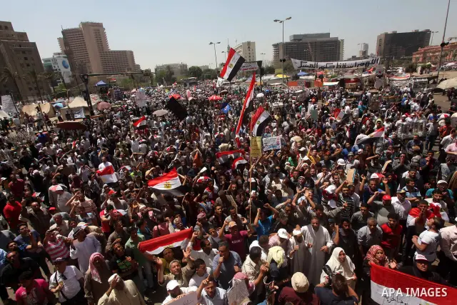 People attend Friday prayers in Tahrir Square in Cairo April 27, 2012. Tens of thousands of Egyptians demanded on Friday that their military rulers stick to a pledge to hand over power by mid-year after a row over who ca...