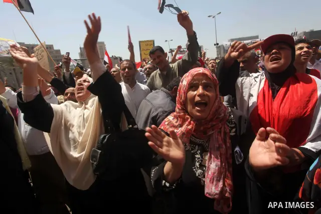 People attend Friday prayers in Tahrir Square in Cairo April 27, 2012. Tens of thousands of Egyptians demanded on Friday that their military rulers stick to a pledge to hand over power by mid-year after a row over who ca...