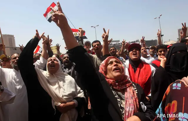 People attend Friday prayers in Tahrir Square in Cairo April 27, 2012. Tens of thousands of Egyptians demanded on Friday that their military rulers stick to a pledge to hand over power by mid-year after a row over who ca...