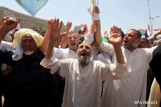 People attend Friday prayers in Tahrir Square in Cairo April 27, 2012. Tens of thousands of Egyptians demanded on Friday that their military rulers stick to a pledge to hand over power by mid-year after a row over who ca...