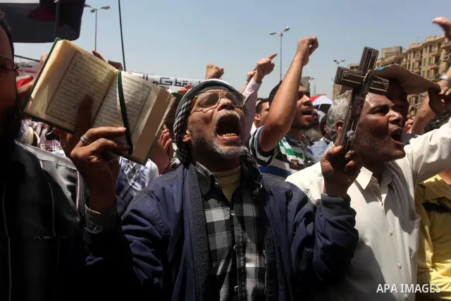 People attend Friday prayers in Tahrir Square in Cairo April 27, 2012. Tens of thousands of Egyptians demanded on Friday that their military rulers stick to a pledge to hand over power by mid-year after a row over who ca...