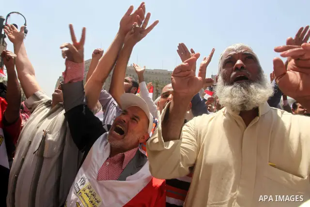 People attend Friday prayers in Tahrir Square in Cairo April 27, 2012. Tens of thousands of Egyptians demanded on Friday that their military rulers stick to a pledge to hand over power by mid-year after a row over who ca...