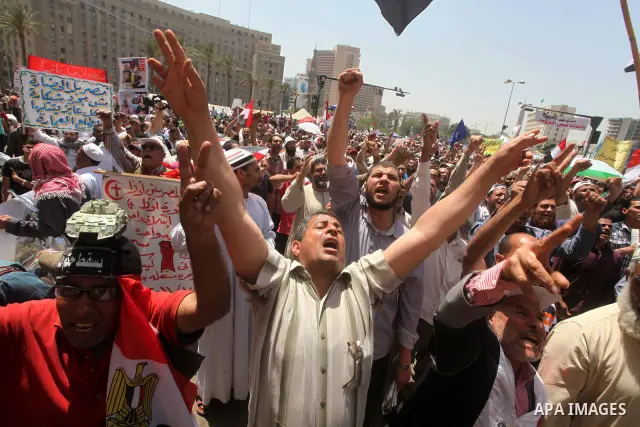 People attend Friday prayers in Tahrir Square in Cairo April 27, 2012. Tens of thousands of Egyptians demanded on Friday that their military rulers stick to a pledge to hand over power by mid-year after a row over who ca...