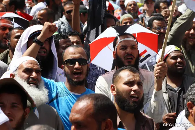 People attend Friday prayers in Tahrir Square in Cairo April 27, 2012. Tens of thousands of Egyptians demanded on Friday that their military rulers stick to a pledge to hand over power by mid-year after a row over who ca...