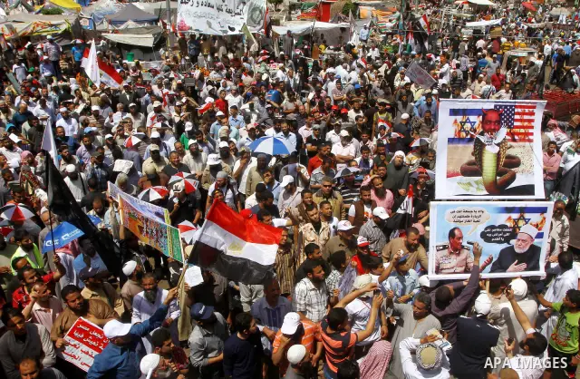 People attend Friday prayers in Tahrir Square in Cairo April 27, 2012. Tens of thousands of Egyptians demanded on Friday that their military rulers stick to a pledge to hand over power by mid-year after a row over who ca...
