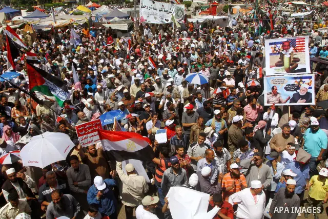 People attend Friday prayers in Tahrir Square in Cairo April 27, 2012. Tens of thousands of Egyptians demanded on Friday that their military rulers stick to a pledge to hand over power by mid-year after a row over who ca...