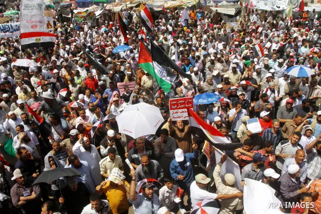 People attend Friday prayers in Tahrir Square in Cairo April 27, 2012. Tens of thousands of Egyptians demanded on Friday that their military rulers stick to a pledge to hand over power by mid-year after a row over who ca...
