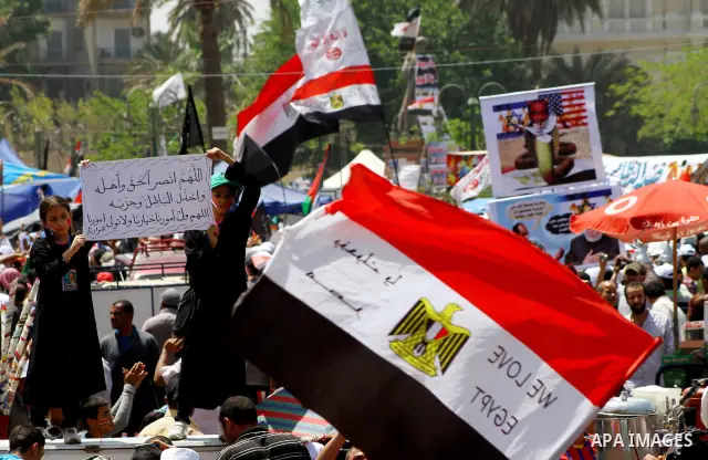 People attend Friday prayers in Tahrir Square in Cairo April 27, 2012. Tens of thousands of Egyptians demanded on Friday that their military rulers stick to a pledge to hand over power by mid-year after a row over who ca...