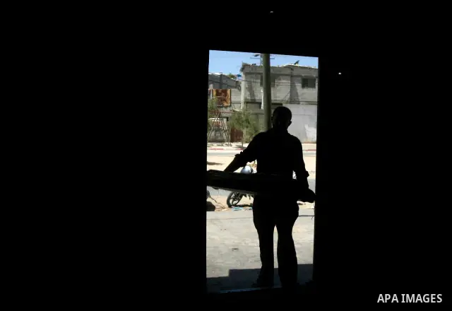 A Palestinian man prepare to bake loaves of bread in a traditional mud oven in Rafah refugee camp, southern Gaza Strip on April 28, 2012. Photo by Eyad Al Baba