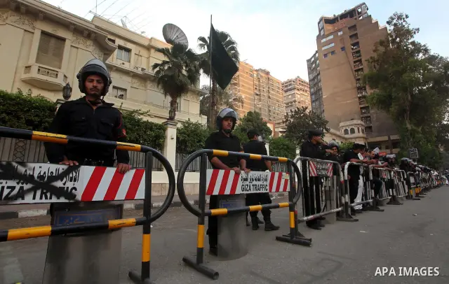 Egyptian security forces stand guard outside the Saudi Embassy in Cairo, Egypt during a demonstration to demand the release of an Egyptian human rights lawyer detained in Saudi Arabia for allegedly insulting the kingdom'...