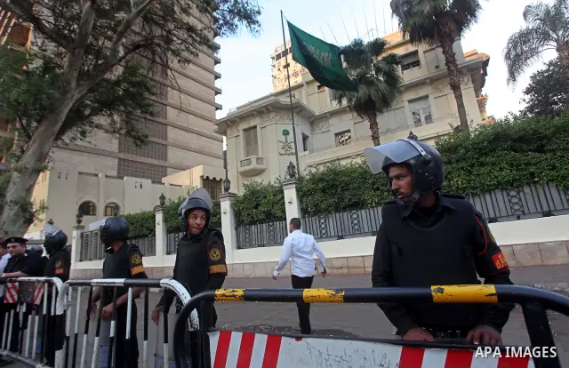 Egyptian security forces stand guard outside the Saudi Embassy in Cairo, Egypt during a demonstration to demand the release of an Egyptian human rights lawyer detained in Saudi Arabia for allegedly insulting the kingdom'...