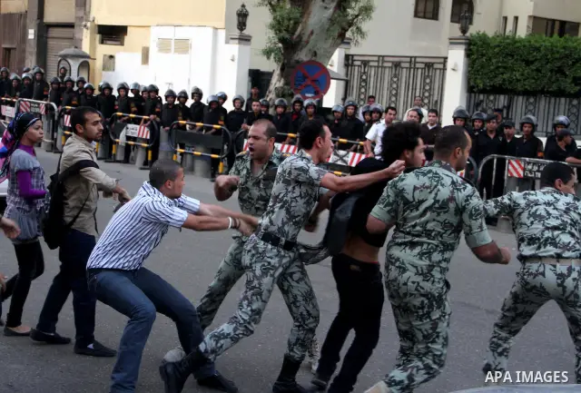 An Egyptian protester scuffles with security forces as they arrest a fellow demonstrator outside the Saudi embassy in Cairo on April 28, 2012. Saudi Arabia has decided to recall its ambassador to Cairo and close diplomat...
