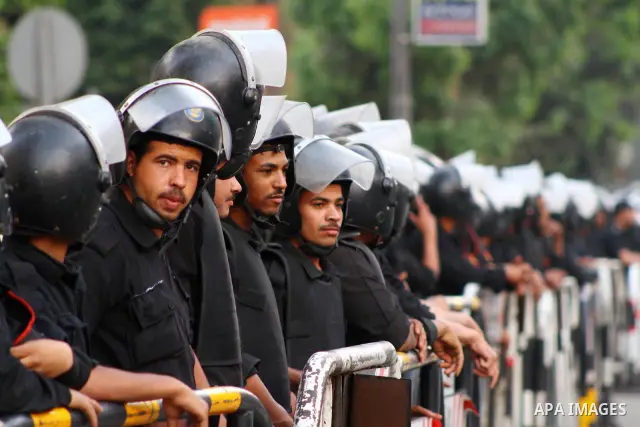 Egyptian security forces stand guard outside the Saudi Embassy in Cairo, Egypt during a demonstration to demand the release of an Egyptian human rights lawyer detained in Saudi Arabia for allegedly insulting the kingdom'...