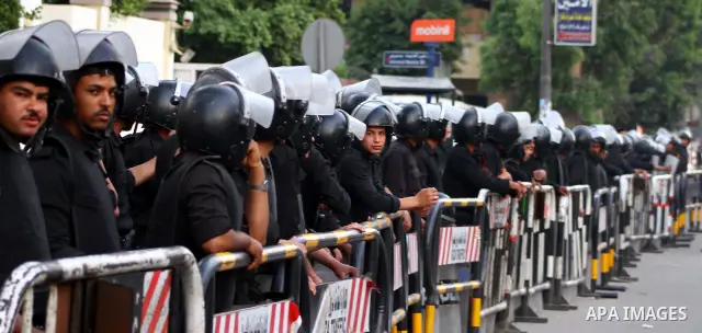 Egyptian security forces stand guard outside the Saudi Embassy in Cairo, Egypt during a demonstration to demand the release of an Egyptian human rights lawyer detained in Saudi Arabia for allegedly insulting the kingdom'...