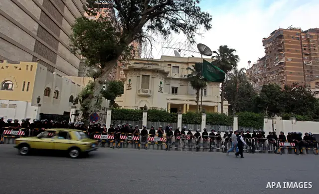 Egyptian security forces stand guard outside the Saudi Embassy in Cairo, Egypt during a demonstration to demand the release of an Egyptian human rights lawyer detained in Saudi Arabia for allegedly insulting the kingdom'...
