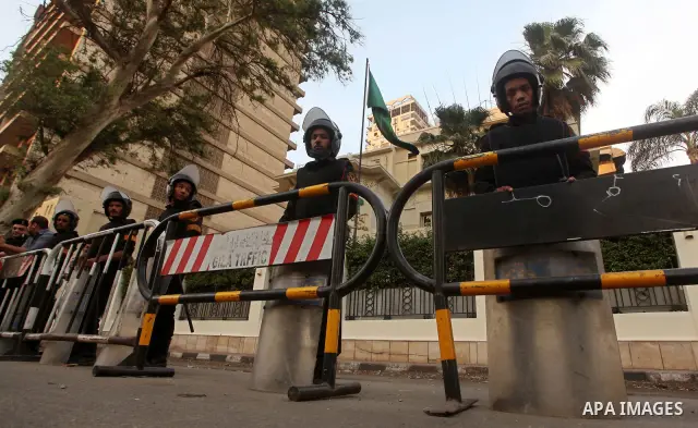 Egyptian security forces stand guard outside the Saudi Embassy in Cairo, Egypt during a demonstration to demand the release of an Egyptian human rights lawyer detained in Saudi Arabia for allegedly insulting the kingdom'...