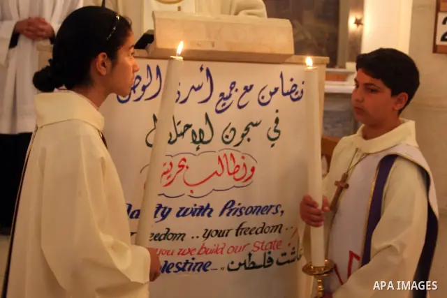 Palestinian Christians attend a special service in support of jailed Palestinians on hunger strike in Israeli prisons at a church in the West Bank city of Ramallah on April 29, 2012. Over the past week, Over 1,350 Palest...