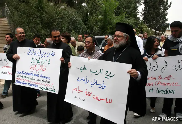 Palestinian priests and Christians, protest in support of jailed Palestinians on hunger strike in Israeli prisons in the West Bank city of Ramallah on April 29, 2012. Over the past week, over 1,350 Palestinian prisoners...