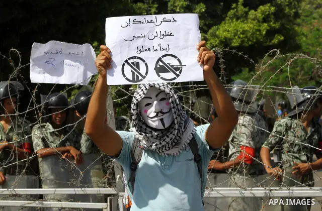 Egyptian protesters march back to the Ministry of Defense after battling thugs in the nearby streets of the Abasseya neighborhood of Cairo for several hours on Sunday, April 29, 2012. The army had mover back their securi...