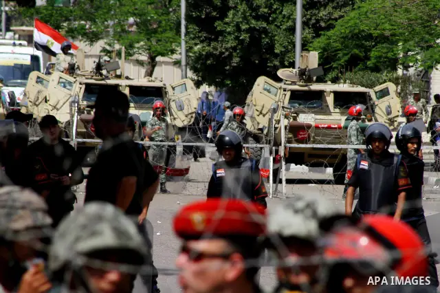 Egyptian protesters march back to the Ministry of Defense after battling thugs in the nearby streets of the Abasseya neighborhood of Cairo for several hours on Sunday, April 29, 2012. The army had mover back their securi...