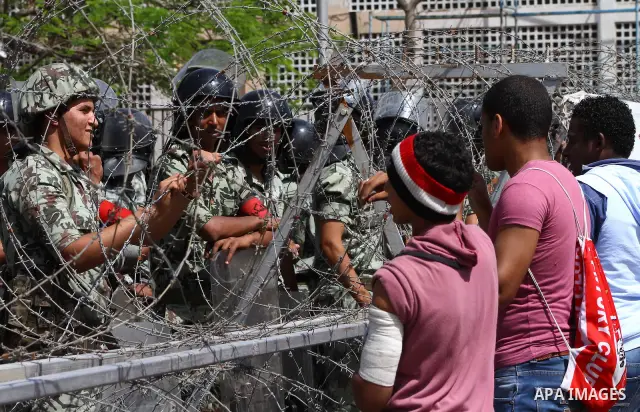 Egyptian protesters march back to the Ministry of Defense after battling thugs in the nearby streets of the Abasseya neighborhood of Cairo for several hours on Sunday, April 29, 2012. The army had mover back their securi...