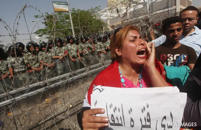 Egyptian protesters march back to the Ministry of Defense after battling thugs in the nearby streets of the Abasseya neighborhood of Cairo for several hours on Sunday, April 29, 2012. The army had mover back their securi...