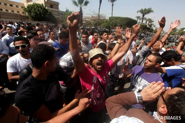 Egyptian protesters march back to the Ministry of Defense after battling thugs in the nearby streets of the Abasseya neighborhood of Cairo for several hours on Sunday, April 29, 2012. The army had mover back their securi...