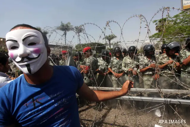 Egyptian protesters march back to the Ministry of Defense after battling thugs in the nearby streets of the Abasseya neighborhood of Cairo for several hours on Sunday, April 29, 2012. The army had mover back their securi...