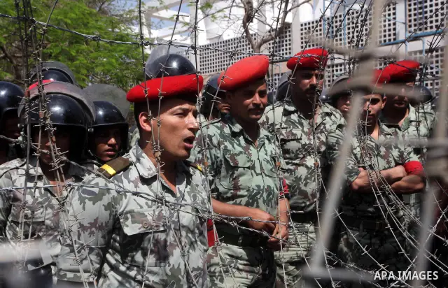 Egyptian protesters march back to the Ministry of Defense after battling thugs in the nearby streets of the Abasseya neighborhood of Cairo for several hours on Sunday, April 29, 2012. The army had mover back their securi...