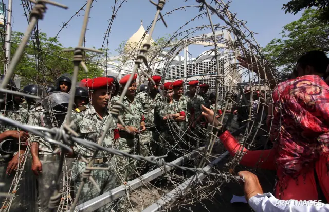 Egyptian protesters march back to the Ministry of Defense after battling thugs in the nearby streets of the Abasseya neighborhood of Cairo for several hours on Sunday, April 29, 2012. The army had mover back their securi...
