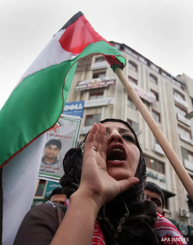 A Palestinian girl chant slogans during a protest to call for the release of Palestinian prisoners held in Israeli jails in the West Bank village of Nabi Saleh near Ramallah, on April 27, 2012. Photo by Issam Rimawi