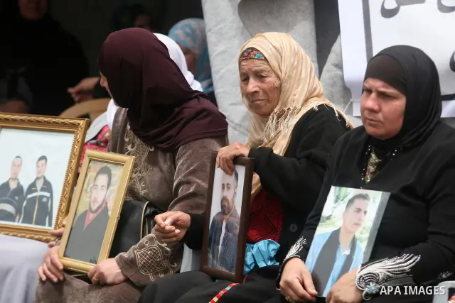 Palestinian protesters hold up banners and portraits of a prisoners jailed in Israel,during a rally in solidarity with prisoners in Israeli jails, in the West Bank city of Ramallah, April 29, 2012.Over the past week, ove...