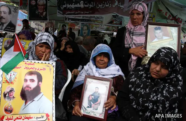 Palestinian women shout slogans during a demonstration for the release of Palestinian prisoners held in Israeli jails in Gaza City on April 30, 2012. At least 1,350 Palestinian prisoners being held in Israel are observin...