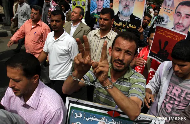 Palestinians shout slogans during a demonstration for the release of Palestinian prisoners held in Israeli jails in Gaza City on April 30, 2012. At least 1,350 Palestinian prisoners being held in Israel are observing an...