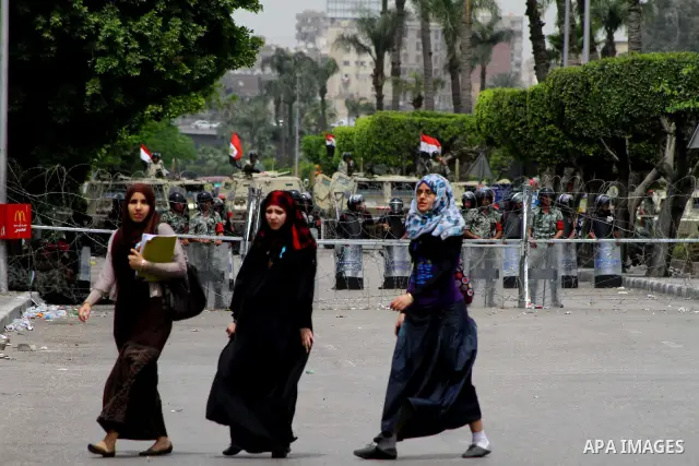 Egyptian students walk near the Ministry of Defense in the Abbassiya district of Cairo April 30, 2012. Protesters continued their sit-in on April 30 after they were attacked two days earlier, which resulted in the death...
