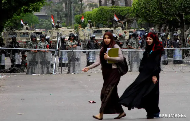 Egyptian students walk near the Ministry of Defense in the Abbassiya district of Cairo April 30, 2012. Protesters continued their sit-in on April 30 after they were attacked two days earlier, which resulted in the death...