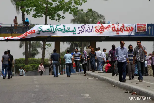 Egyptian Protesters walk near the Ministry of Defense in the Abbassiya district of Cairo April 30, 2012. Protesters continued their sit-in on April 30 after they were attacked two days earlier, which resulted in the deat...