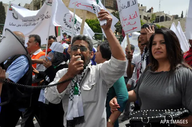 Palestinian workers shouting and calling Palestinian government to improve conditions of workers and create jobs during a protest in the West Bank city of Nablus on May 01,2012. Photo by Nedal shtieh