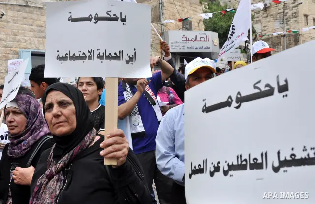 Palestinian workers shouting and calling Palestinian government to improve conditions of workers and create jobs during a protest in the West Bank city of Nablus on May 01,2012. Photo by Nedal shtieh