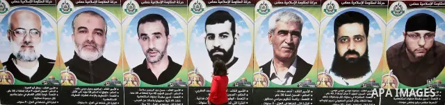 A Palestinian girl sees for prisoners photo during a rally to show solidarity with Palestinians prisoners held in Israeli jails, in Gaza City, May 01, 2012. Human rights groups say up to 2,000 prisoners have joined an op...